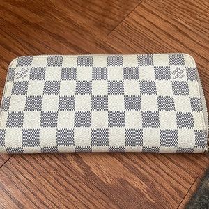This is an LV look-alike wallet in a grey checkered pattern.